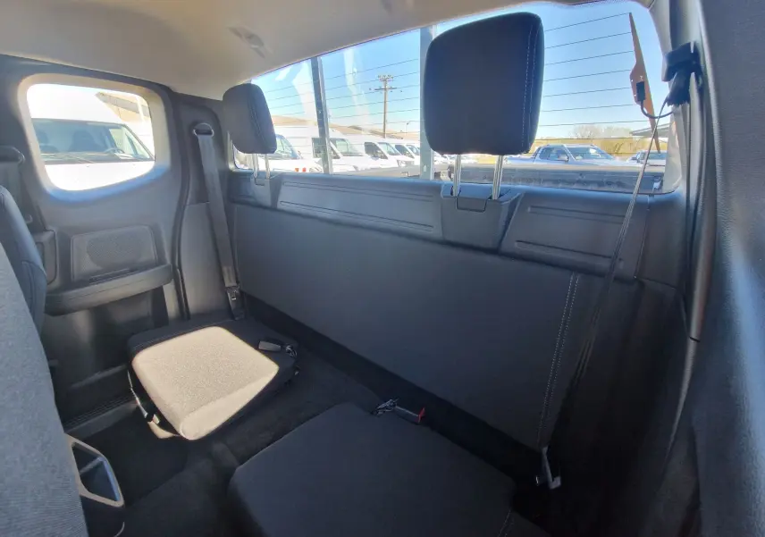 Vue intérieure arrière du Ford Ranger Super Cabine 2026, sièges noirs compacts avec appuie-têtes et ceinture de sécurité visible.