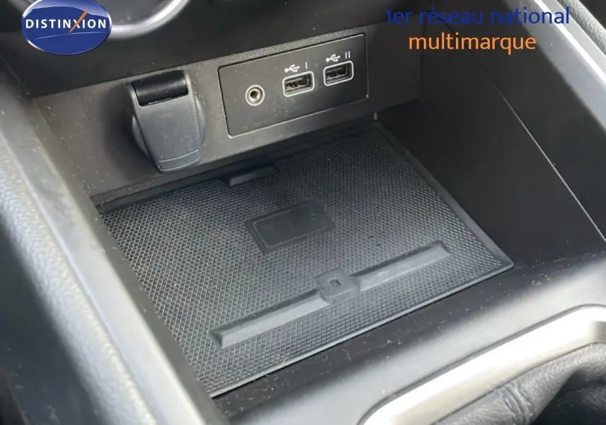 Gros plan sur la console centrale noire de la Renault Clio V 1.0 ECO-G 100CH TECHNO, montrant les ports USB et prise 12V.