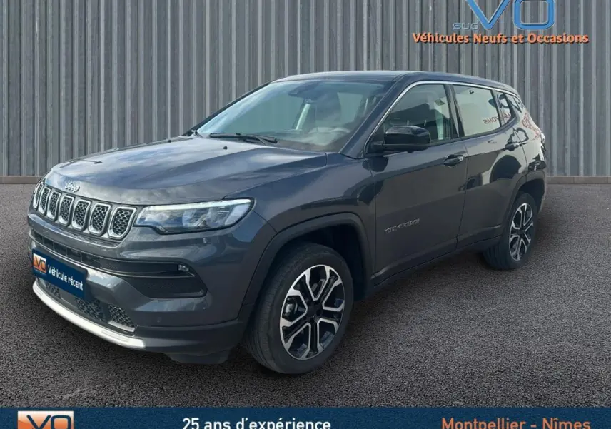 Vue 3/4 avant d'un Jeep Compass gris 2024 avec jantes alliage 18 pouces et calandre distinctive à sept fentes.