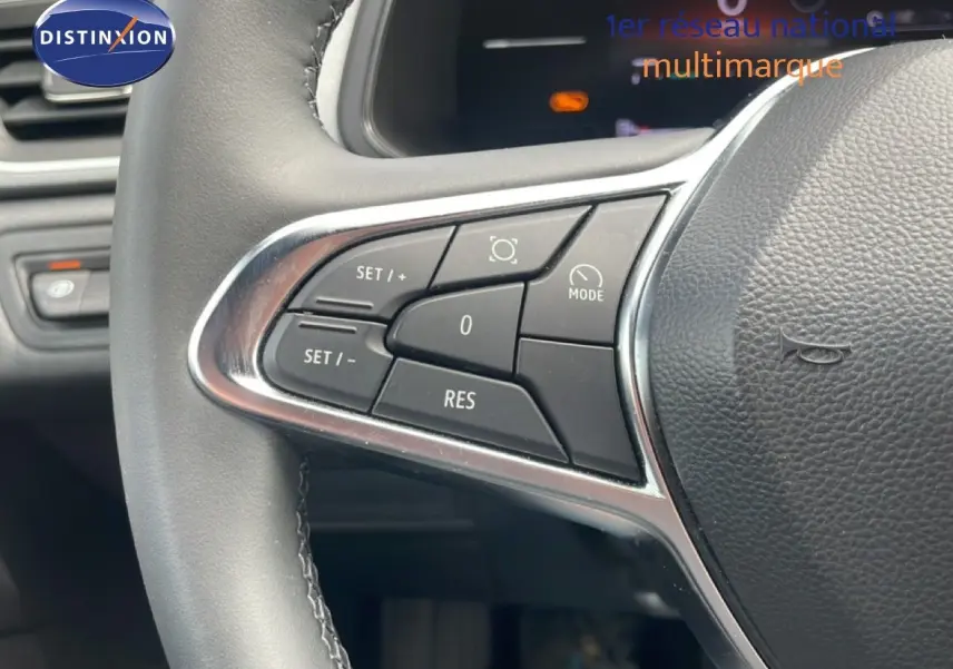 Gros plan sur les commandes au volant du Renault Captur 2025, finition gris cassiopée métal avec toit noir.