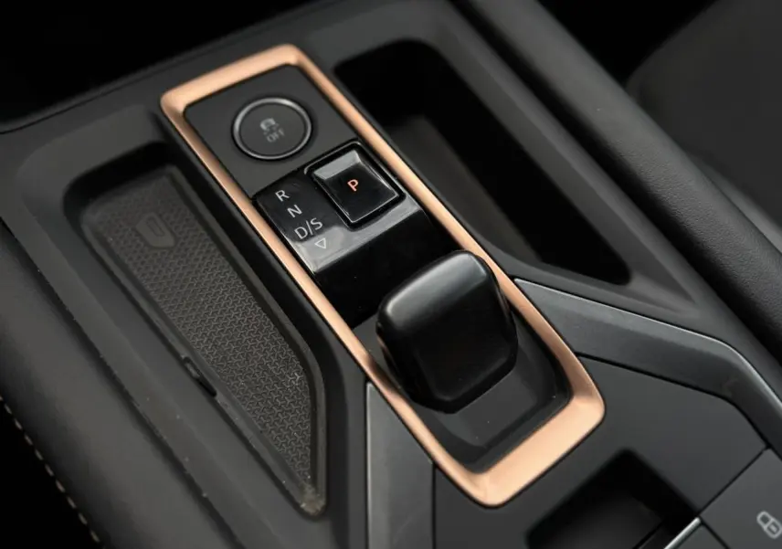 Gros plan sur la commande de boîte automatique noire avec contour cuivré dans l’habitacle du CUPRA Formentor.