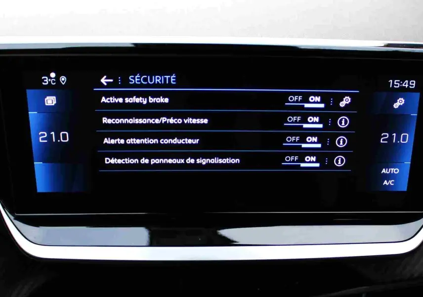 Écran central du tableau de bord du Peugeot 2008 II affichant les réglages de sécurité et la climatisation à 21°C.