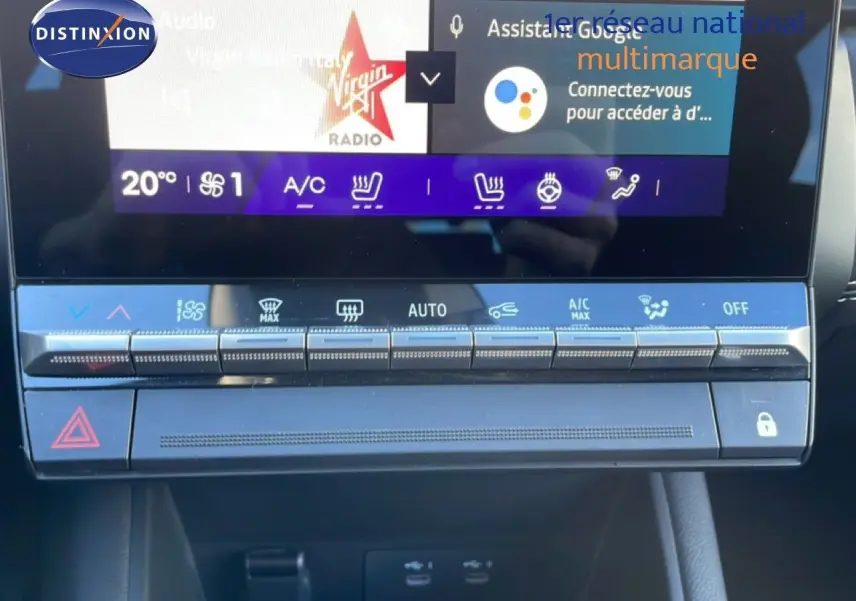 Gros plan sur la console centrale tactile du Renault Symbioz 2025 bleu Iron Metal, affichant les commandes climatisation et sièges chauffants.