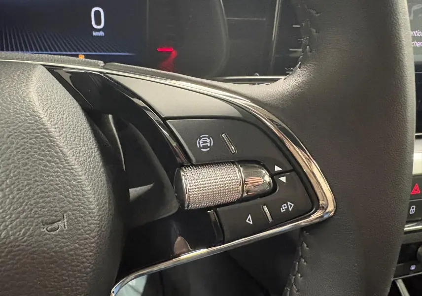 Gros plan sur les commandes à droite du volant du Skoda Kamiq 2023, finition Business, avec molette métallique et boutons noirs.