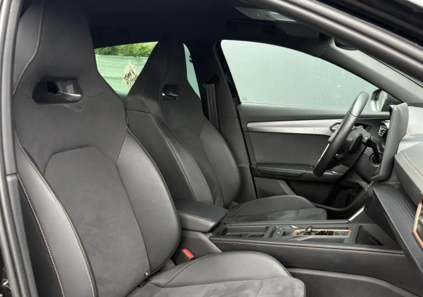 Vue intérieure côté conducteur du CUPRA Formentor 2025 noir Minuit, sièges baquets cuir et alcantara avec surpiqûres contrastées.