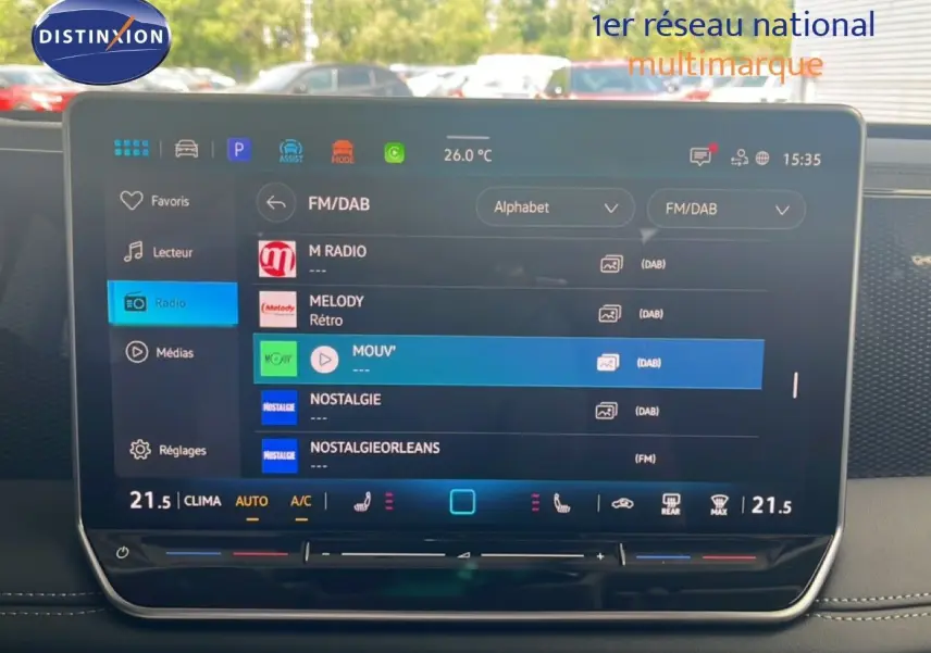 Écran tactile central du Volkswagen Tiguan 2026 affichant les options radio FM/DAB et la température intérieure à 21,5°C.