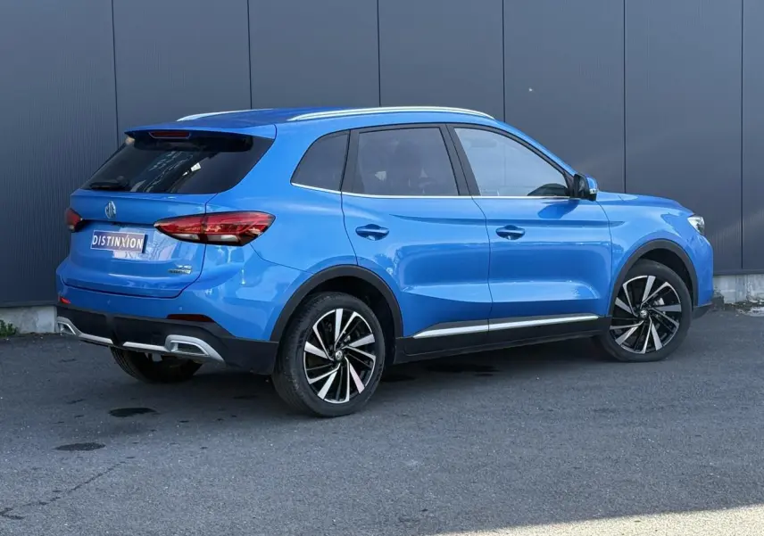 Vue 3/4 arrière droite du MG ZS 1.5 Hybrid+ 197 Luxury bleu Como avec jantes alliage 18 pouces et toit panoramique.