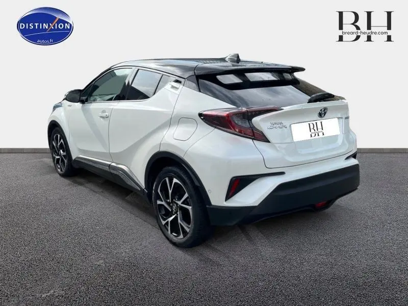 Vue 3/4 arrière droite du Toyota C-HR 122h Collection blanc nacré bi-ton avec jantes alu et toit noir.