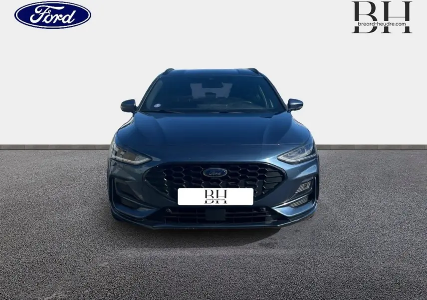 Vue de face d'une Ford Focus SW 2024 bleu azur métallisé avec calandre noire et phares LED fins.