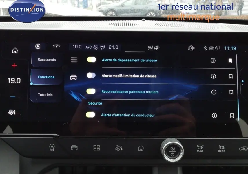 Écran tactile central du Jeep Compass 2026 montrant les réglages d’alerte de sécurité et climatisation.