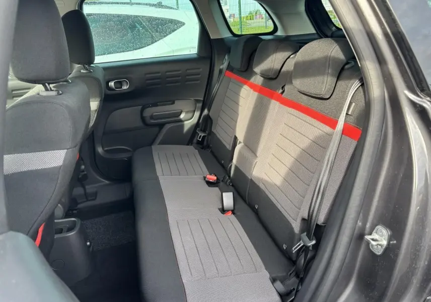Vue intérieure côté droit sur la banquette arrière grise avec bande rouge du Citroën C3 Aircross 2021.