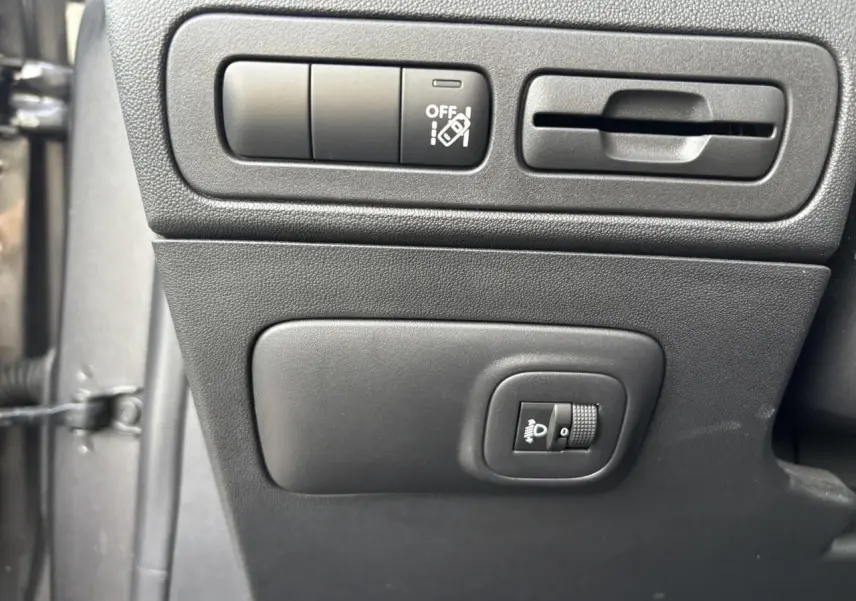 Détail intérieur du panneau de commande côté conducteur de la Citroën C3 Aircross gris platinium, avec réglage des phares.