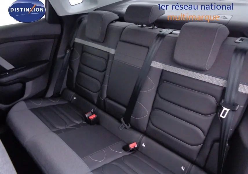Vue intérieure sur la banquette arrière en tissu et cuir noir du Citroën C4 X 2023, avec ceintures de sécurité visibles.