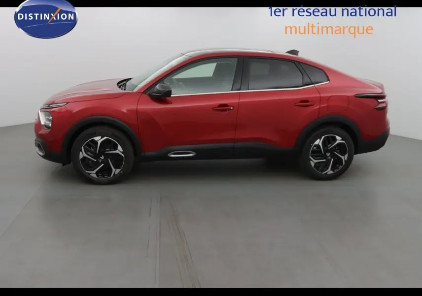 Vue latérale droite d'une Citroën C4 X rouge Elixir métal 2023 avec jantes noires et détails noirs contrastants.