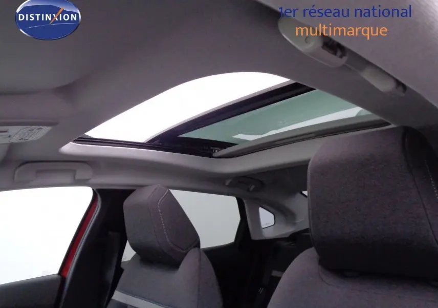 Vue intérieure du toit ouvrant panoramique et des sièges avant gris du Citroën C4 X rouge Elixir Metal.