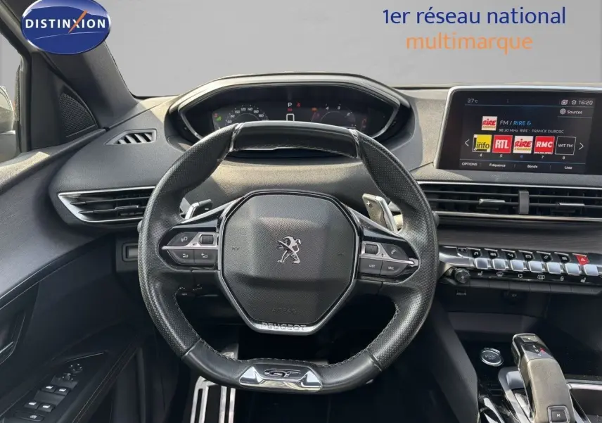 Vue intérieure centrée sur le volant cuir du Peugeot 3008 GT 2018 avec tableau de bord numérique et écran tactile.