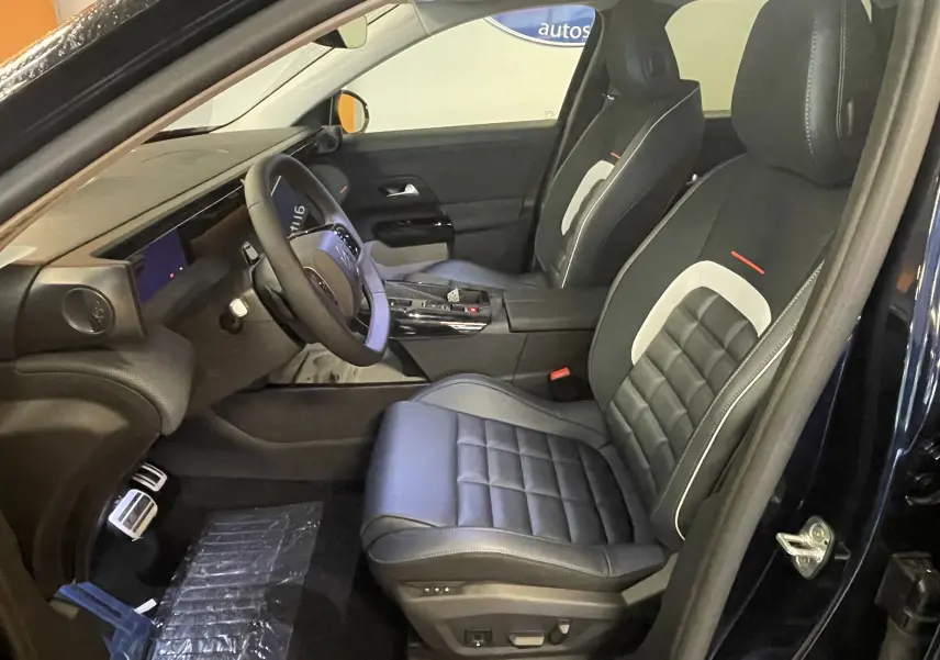 Vue intérieure côté conducteur du Citroën C5 Aircross 2026, sièges noirs avec surpiqûres blanches et tableau de bord moderne.