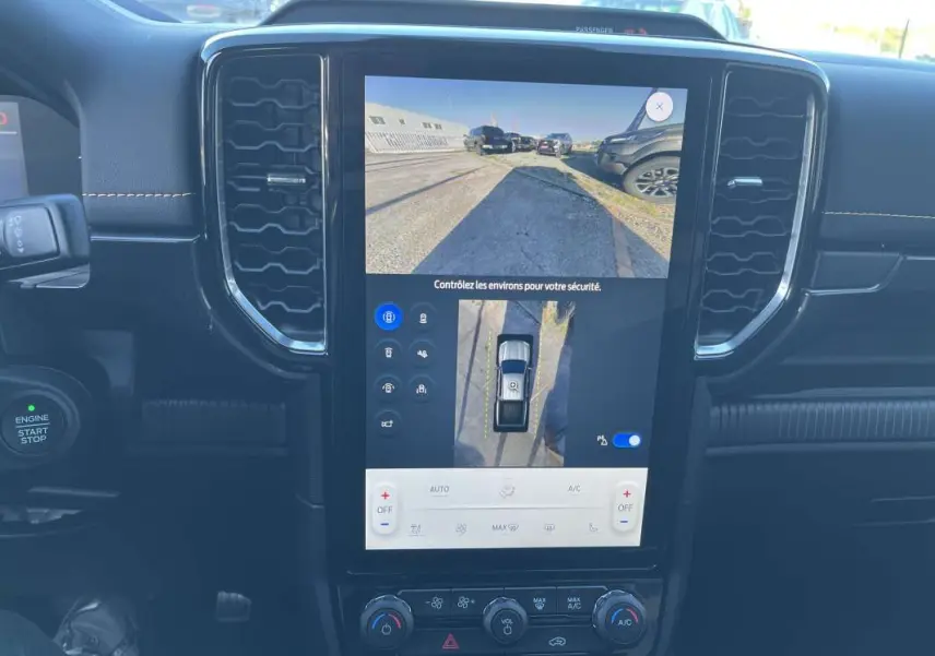 Vue intérieure centrée sur l'écran tactile du Ford Ranger blanc glacier 2026 avec caméra 360° et commandes climatisation.