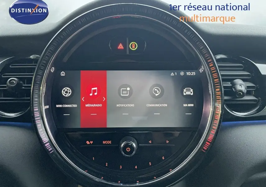Gros plan sur l’écran central rond du tableau de bord de la MINI Cabriolet F57 rouge chili, affichant le menu multimédia.