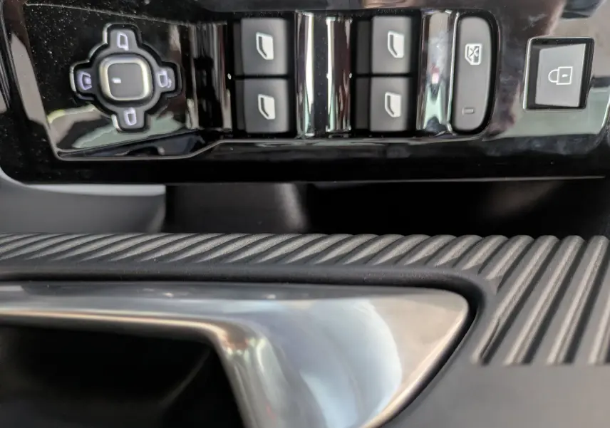 Gros plan sur les commandes de lève-vitres et verrouillage côté conducteur du Citroën C5 Aircross hybride 2026.