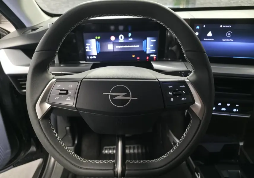 Vue rapprochée du volant noir avec logo Opel au centre et tableau de bord numérique du Frontera-e 2025.