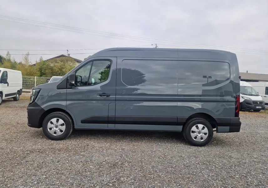 Renault Master gris urbain vu de profil côté gauche, fourgon utilitaire avec jantes acier et détails noirs sur les bas de caisse.
