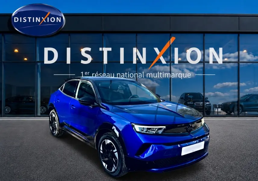 Opel Mokka Electric 156 GS bleu en 3/4 avant droit, avec jantes alu et calandre noire brillante.
