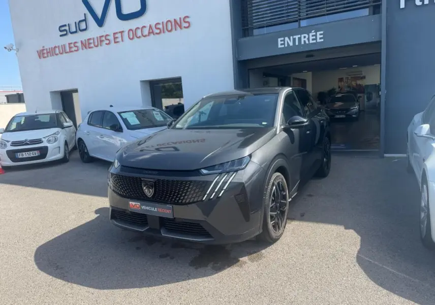 Peugeot 3008 Hybrid gris foncé en 3/4 avant droit, avec calandre noire et jantes alliage 19 pouces visibles.