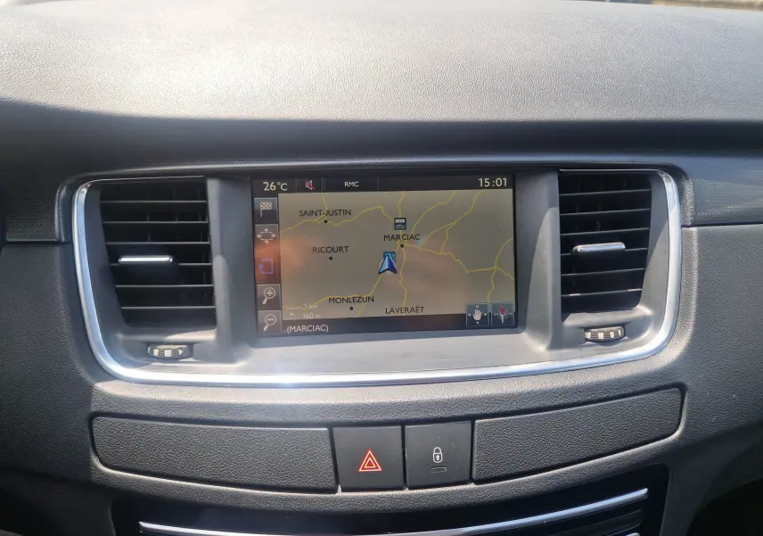 Vue rapprochée de l'écran GPS central et des aérateurs du tableau de bord de la Peugeot 508 SW gris shark.