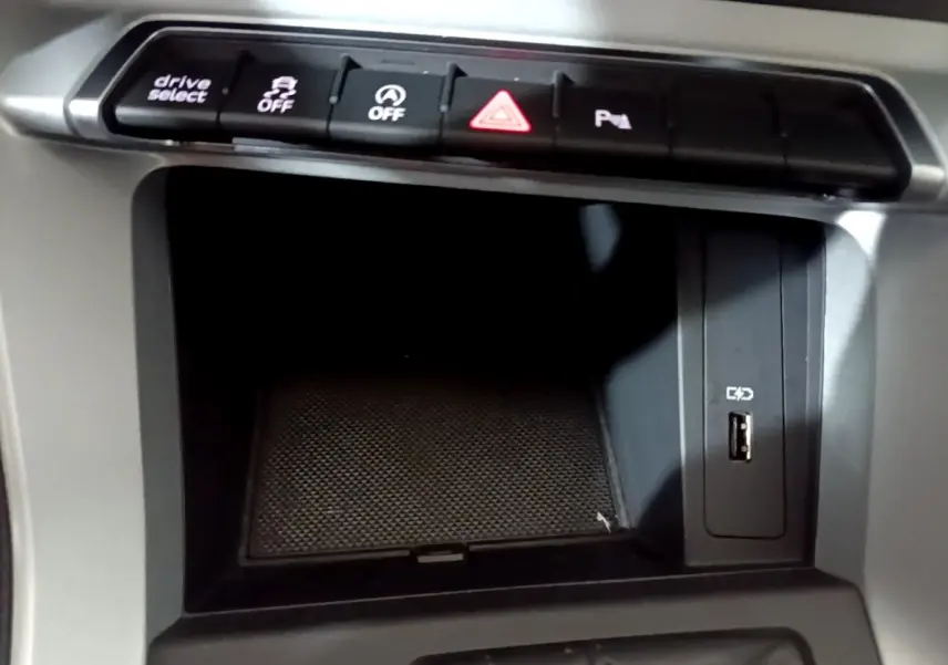 Gros plan sur la console centrale de l'Audi Q3 35 TDI 150 S tronic Business Line 2020 avec boutons de contrôle et port USB.