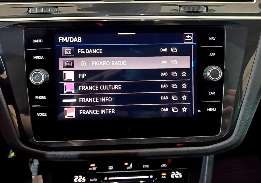 Écran tactile central du Volkswagen Tiguan gris foncé 2021 affichant les stations radio FM/DAB.