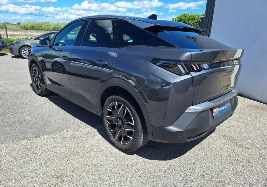Vue 3/4 arrière droite d’un Peugeot 3008 Hybrid gris foncé avec jantes alliage 19 pouces et feux arrière LED distinctifs.