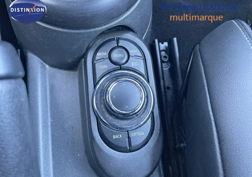 Gros plan sur la molette de commande centrale noire du MINI Cabriolet F57 2023, entourée de boutons fonctionnels.