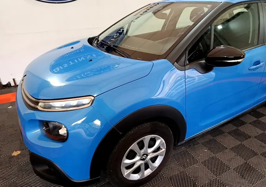 Vue 3/4 avant droit d'une Citroën C3 bleu vif avec rétroviseur noir et jante alliage argentée.