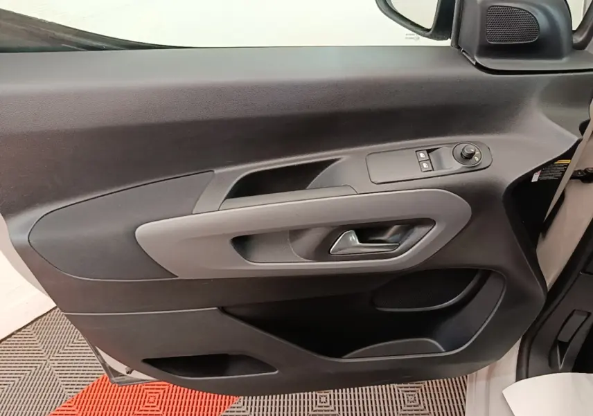 Vue intérieure de la porte avant gauche gris clair du Toyota Proace City Verso Electric avec commandes de vitres et rétroviseur.