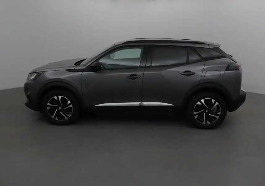 Profil côté gauche du Peugeot 2008 gris platinium 2022 avec jantes alliage et lignes modernes marquées.