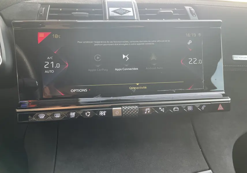 Vue rapprochée de l'écran tactile central et des commandes tactiles du tableau de bord gris noir du DS7 2021.