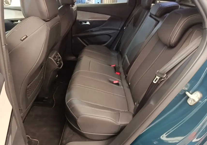 Vue côté droit de la banquette arrière en cuir noir du Peugeot 3008 bleu hybride rechargeable, porte ouverte.