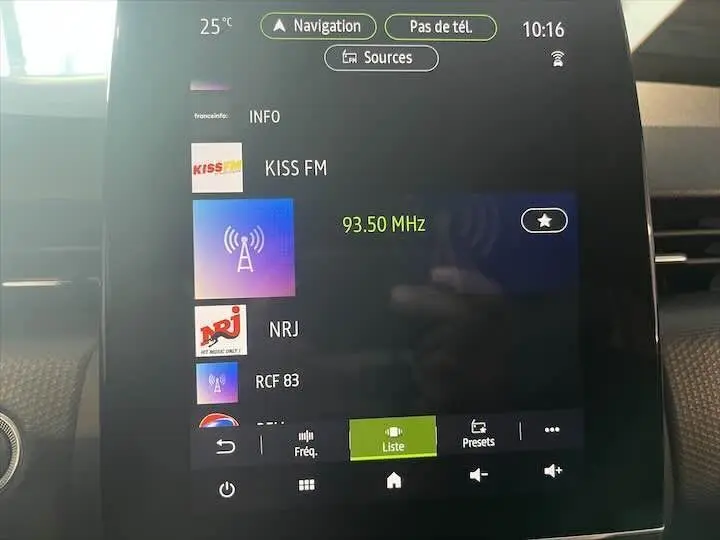 Écran tactile central de la Renault Clio V affichant les stations radio avec interface moderne et commandes tactiles.