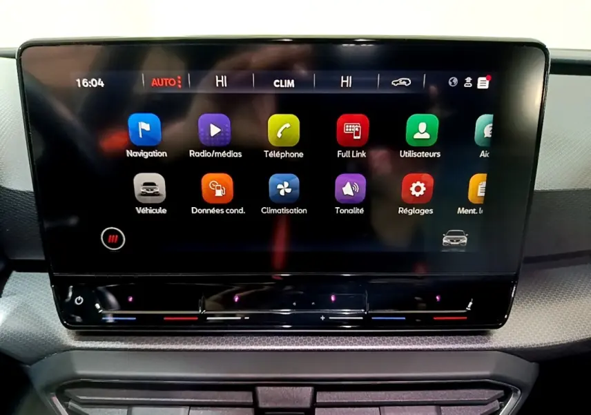 Écran tactile central de la SEAT Leon 2023 affichant les icônes de navigation et climatisation en gros plan.