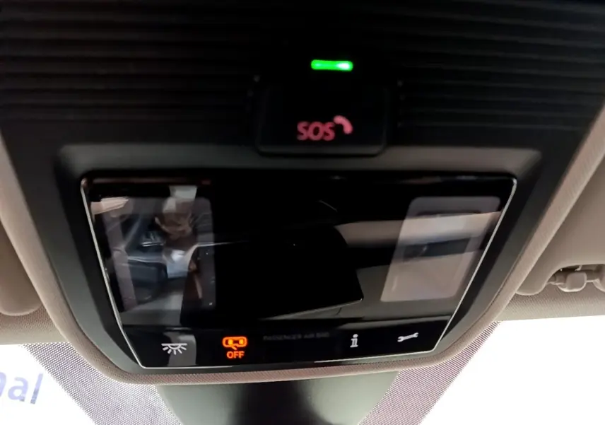 Gros plan sur le panneau de commandes au plafond du SEAT Leon gris foncé, avec bouton SOS et indicateur airbag passager éteint.