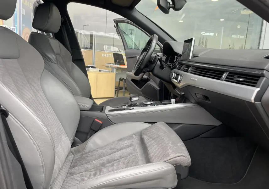 Vue intérieure côté conducteur de l'Audi S4 2016 avec sièges en cuir gris et tableau de bord moderne.