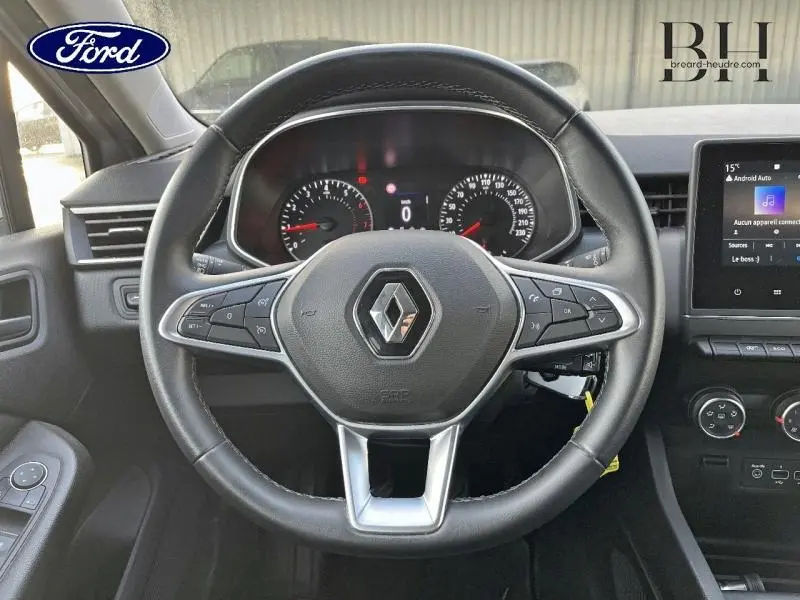 Vue centrée sur le volant noir de la Renault Clio gris platine 2019 avec tableau de bord et écran tactile visible.