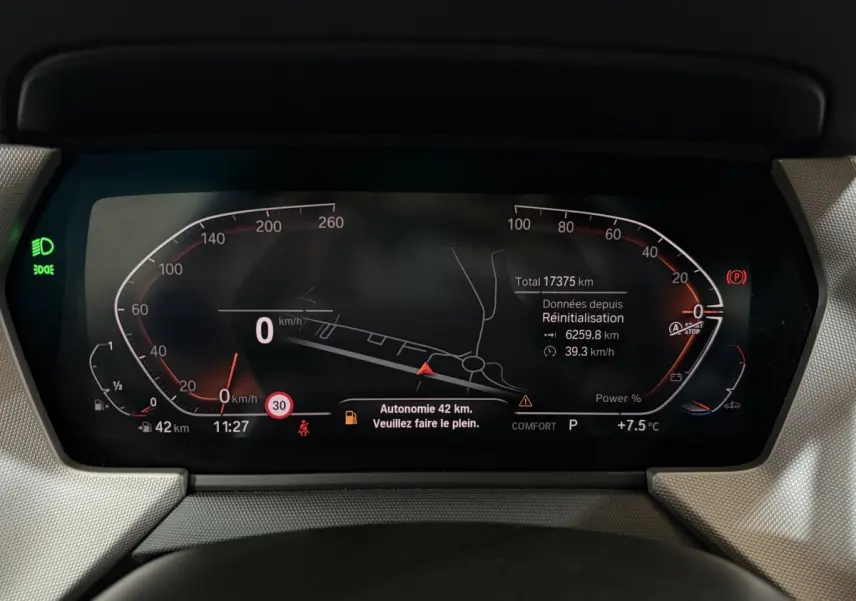 Combiné d'instruments numérique de la BMW Série 1 116i 2023 affichant la vitesse, autonomie et navigation.
