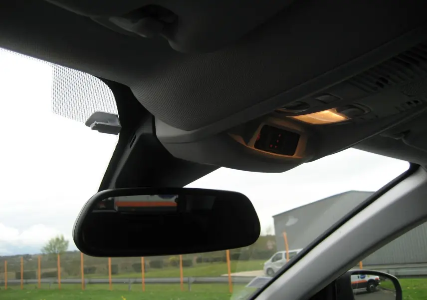 Vue intérieure du rétroviseur central et du plafonnier allumé d'un Peugeot 3008 noir version Business 2020.