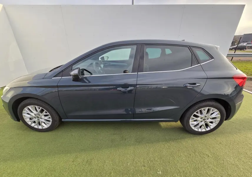 Profil côté gauche d'une SEAT Ibiza 2025 bleu fjord métallisé avec jantes alliage et vitres teintées arrière.