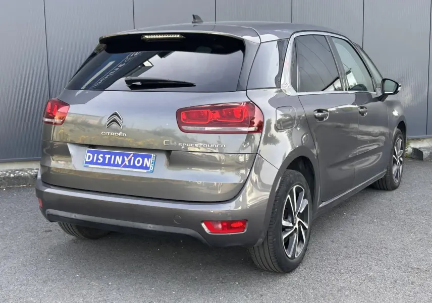 Vue 3/4 arrière droit d'une Citroën C4 Spacetourer gris Platinium avec jantes alliage bi-ton et vitres surteintées.