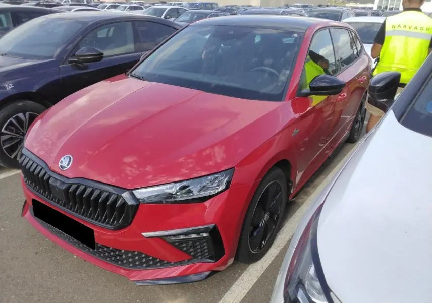 Vue 3/4 avant d'une Skoda Scala TSI 116 Monte-Carlo rouge Velvet avec jantes noires et toit panoramique visible.