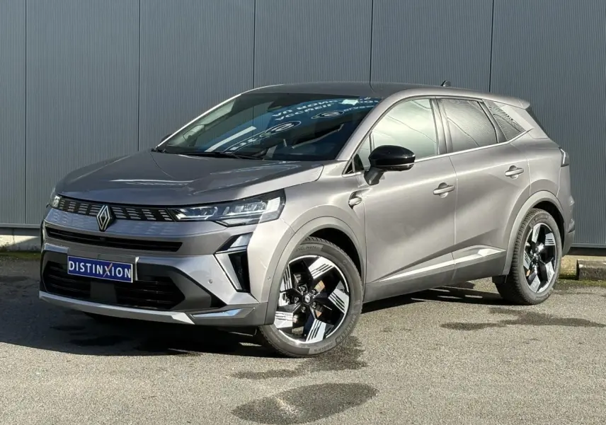 Renault Symbioz gris Cassiopée en 3/4 avant droit, avec jantes 18 pouces et rétroviseurs noirs brillants.