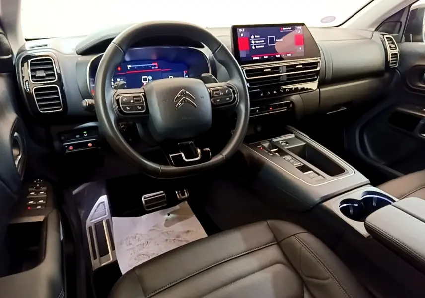Intérieur noir du Citroën C5 Aircross 2023, vue depuis le siège conducteur sur le tableau de bord et l’écran tactile central.